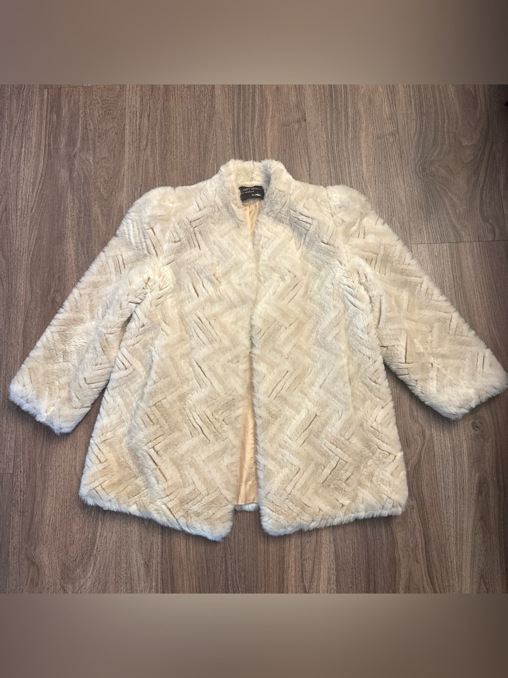 Jacques Saint Laurent Paris cream faux fur coat with chevron pattern. Medium